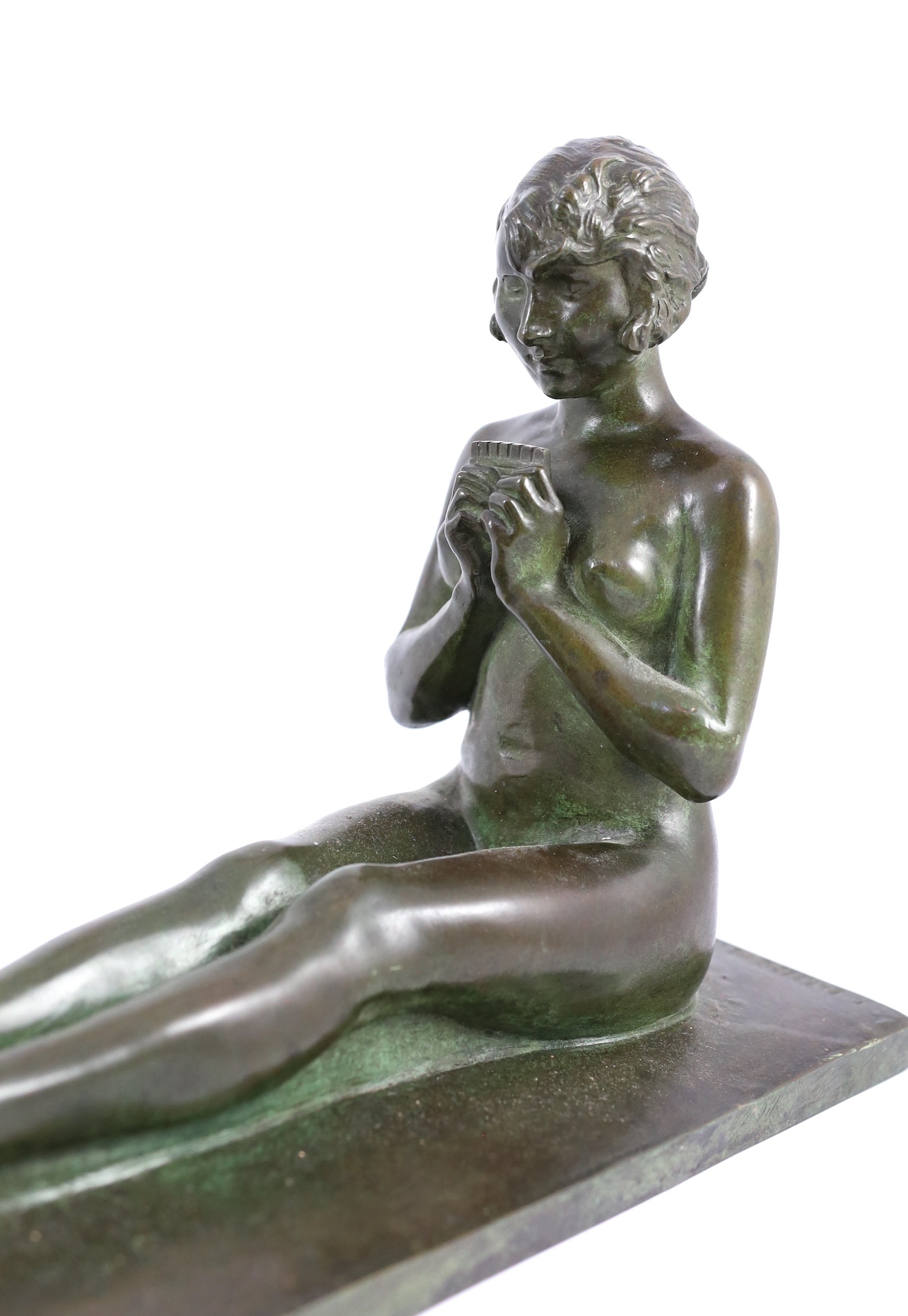 After Paul Silvestre (French, 1884-1976). A patinated Art Deco bronze group of a Bacchante and faun, 27cm high 60cm long